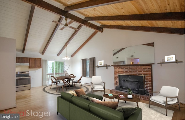 living room with beamed ceiling, light hardwood / wood-style flooring, high vaulted ceiling, a fireplace, and ceiling fan with notable chandelier