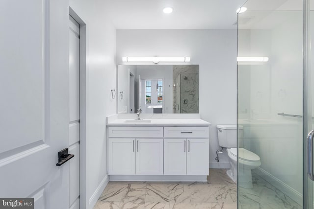 bathroom with vanity, toilet, and a shower with door