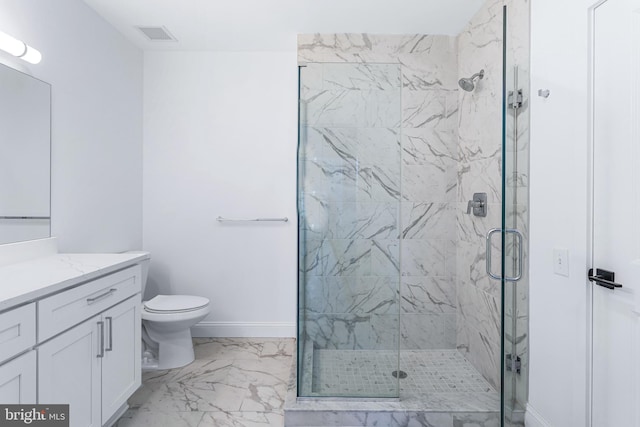 bathroom with vanity, toilet, and a shower with door