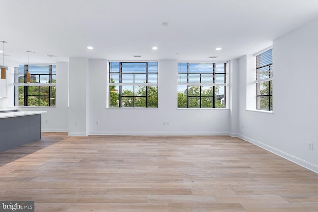 empty room with a healthy amount of sunlight and light wood-type flooring