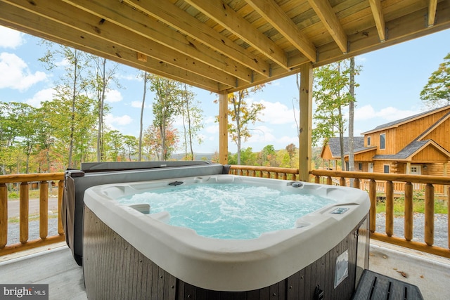 wooden deck featuring a hot tub