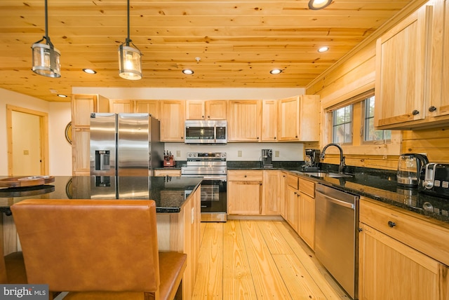 kitchen with pendant lighting, sink, light hardwood / wood-style flooring, appliances with stainless steel finishes, and light brown cabinetry