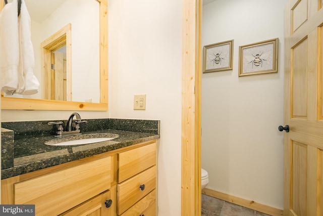 bathroom featuring tile patterned floors, vanity, and toilet