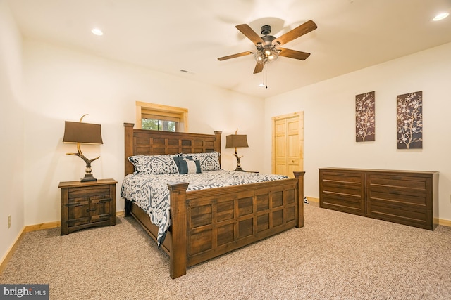 bedroom featuring light carpet, ceiling fan, and a closet