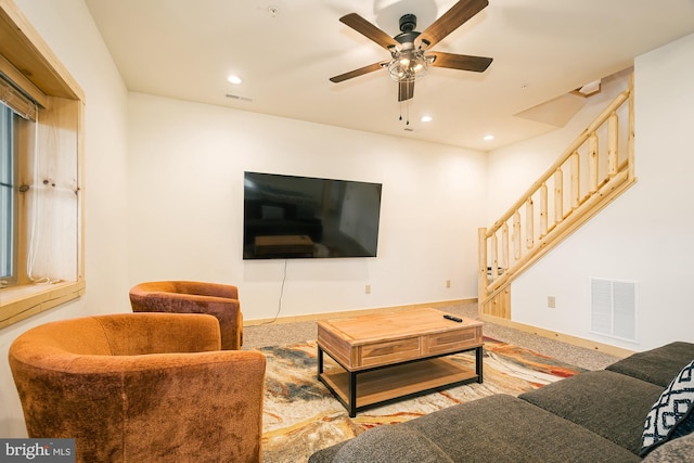 carpeted living room featuring ceiling fan