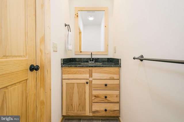 bathroom featuring tile patterned flooring and vanity