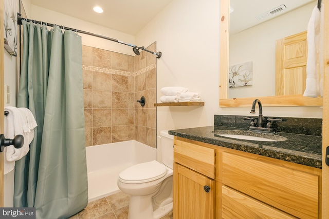 bathroom with tile patterned floors, walk in shower, vanity, and toilet