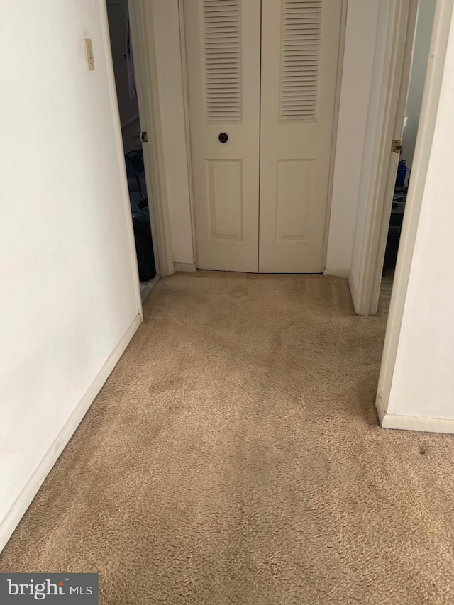 hallway with light carpet