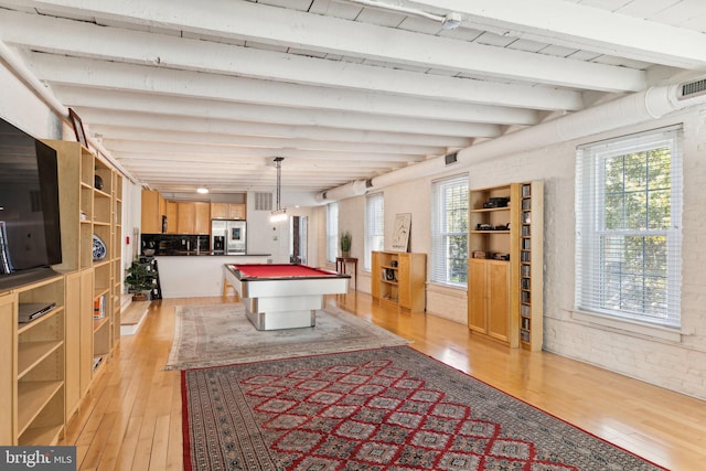 recreation room with brick wall, beam ceiling, light hardwood / wood-style floors, and pool table