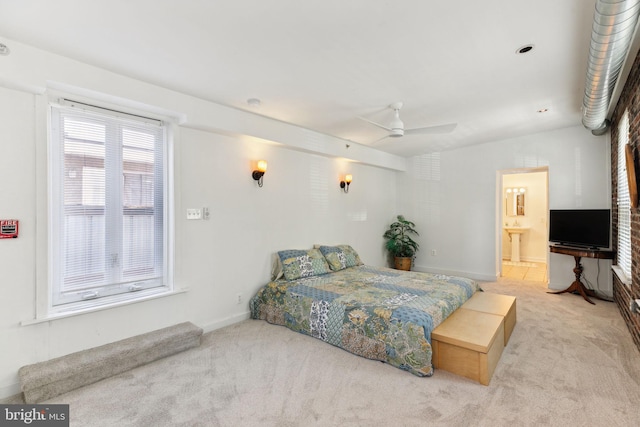 bedroom with light carpet, ensuite bath, ceiling fan, and sink