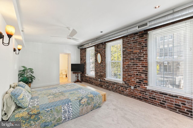 bedroom featuring carpet, ceiling fan, and brick wall