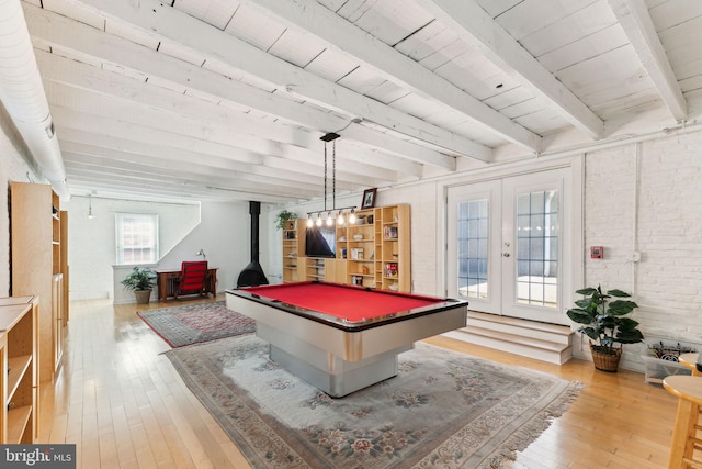 game room with light wood-type flooring, a wood stove, pool table, and french doors