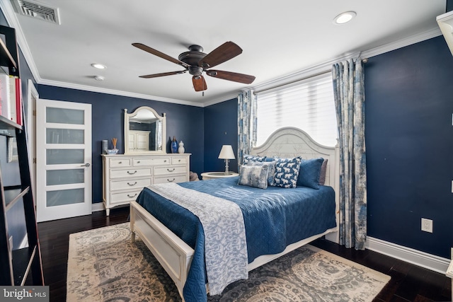 bedroom with crown molding, wood finished floors, ceiling fan, baseboards, and visible vents