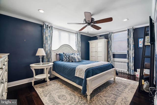 bedroom with dark wood-type flooring, ceiling fan, crown molding, and radiator heating unit