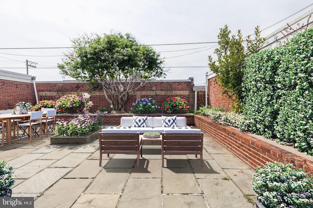 view of patio featuring a fenced backyard, an outdoor hangout area, and outdoor dining area