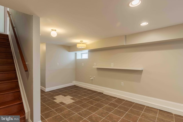 basement featuring dark tile patterned flooring