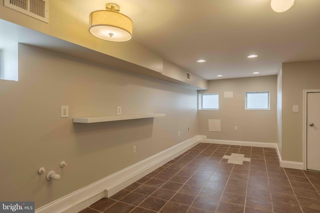 washroom with dark tile patterned flooring