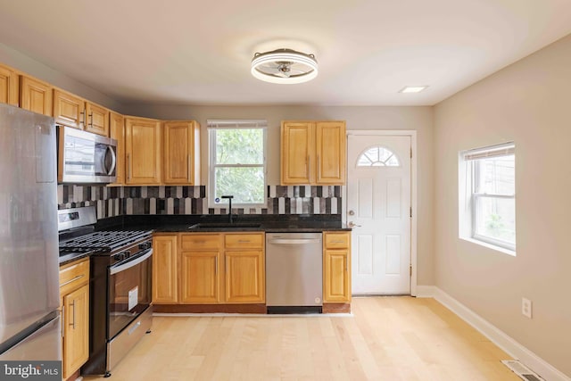 kitchen with appliances with stainless steel finishes, sink, and a wealth of natural light