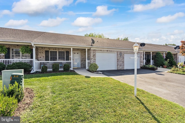 single story home with a front yard, a porch, and a garage