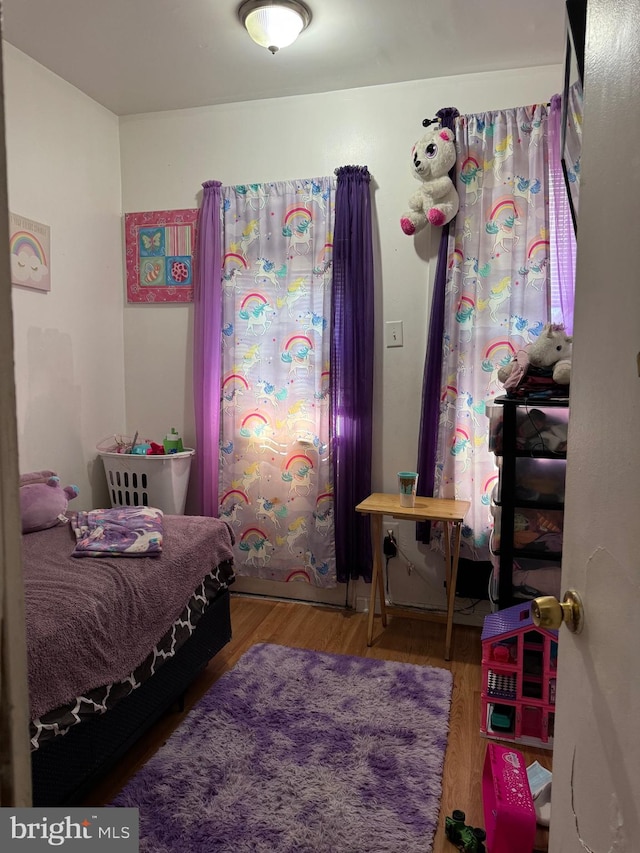 bedroom with wood-type flooring