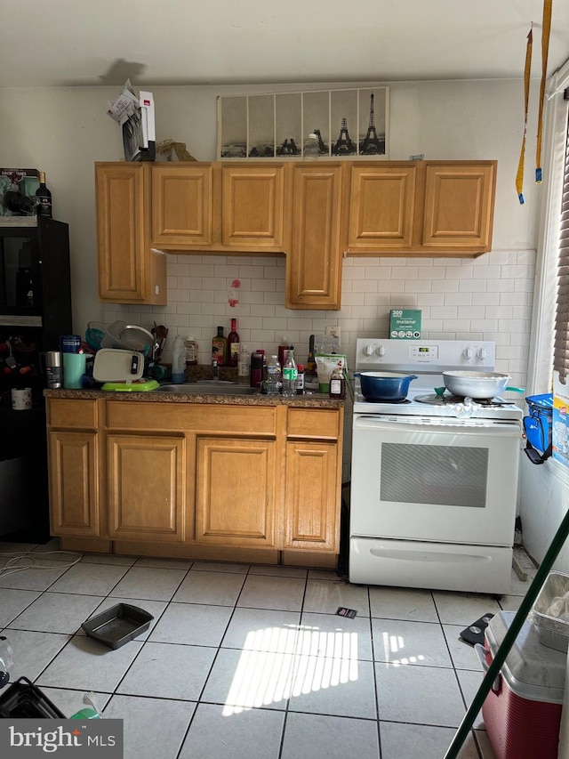 kitchen with decorative backsplash, white electric range oven, light tile patterned floors, and sink