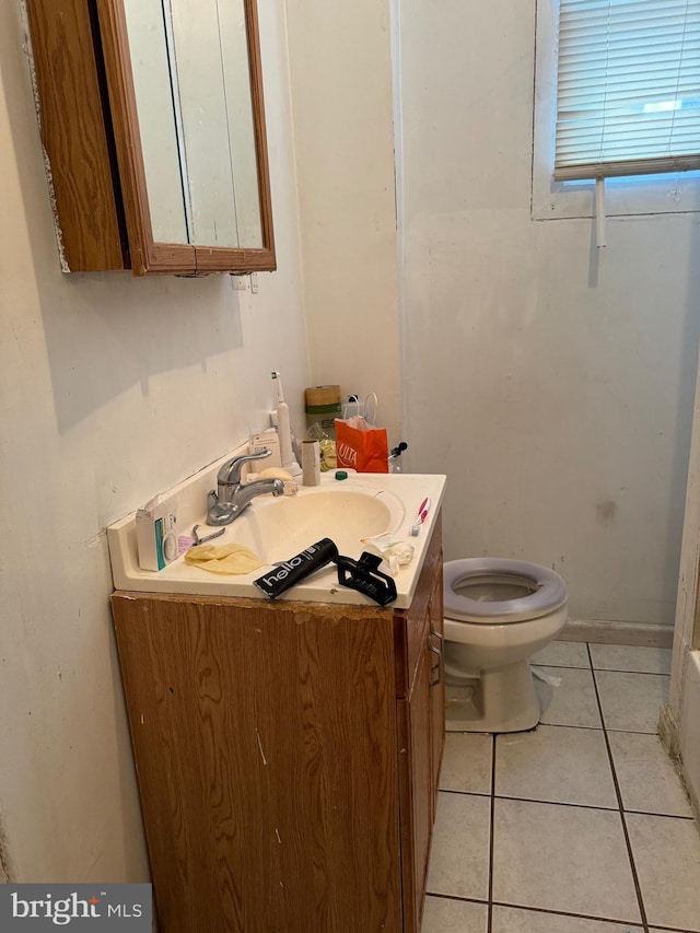 bathroom with vanity, tile patterned flooring, and toilet