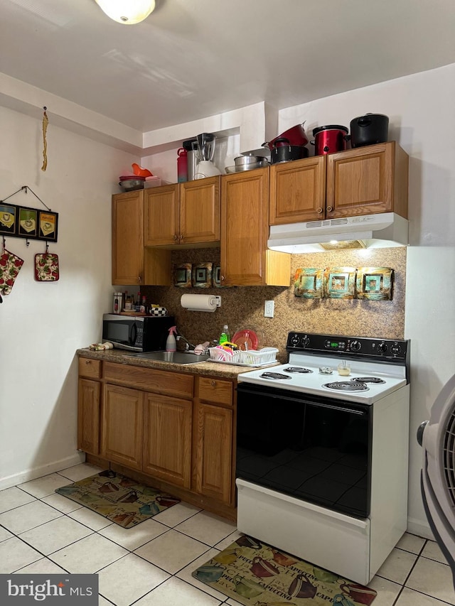 kitchen featuring backsplash, white electric range oven, light tile patterned flooring, and sink