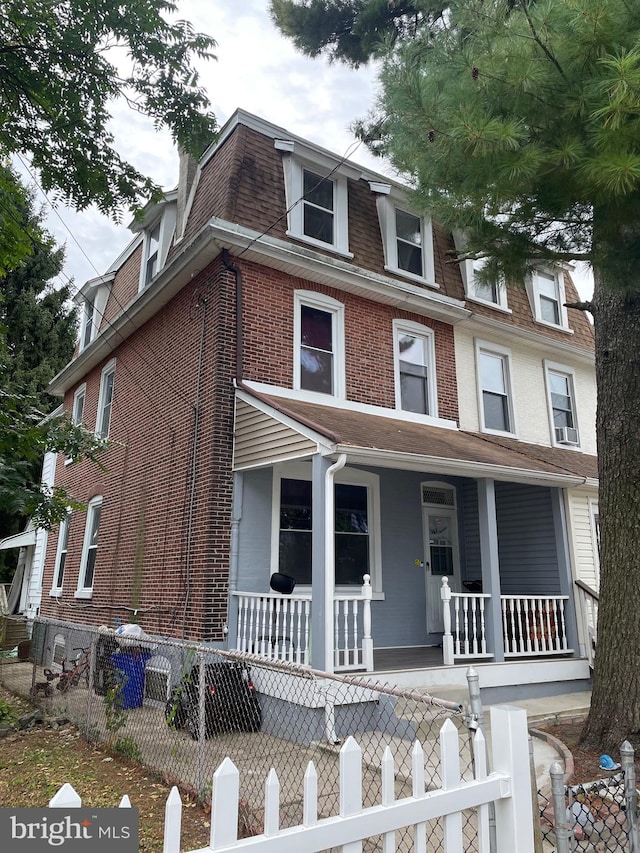 townhome / multi-family property featuring a porch