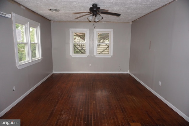 empty room featuring ceiling fan, a textured ceiling, and dark hardwood / wood-style floors