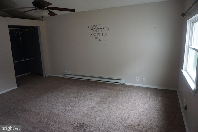 unfurnished bedroom featuring multiple windows, ceiling fan, a baseboard radiator, and a closet