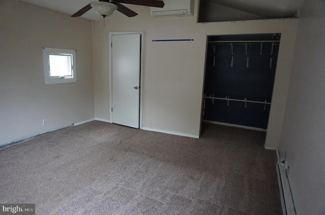 unfurnished bedroom with a closet, vaulted ceiling, carpet, a wall mounted air conditioner, and ceiling fan