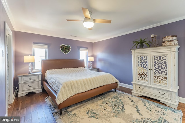 bedroom with ornamental molding, ceiling fan, and dark hardwood / wood-style flooring