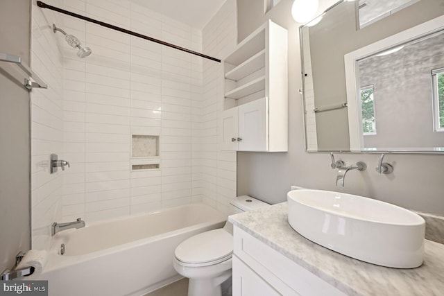 full bathroom featuring vanity, toilet, and tiled shower / bath