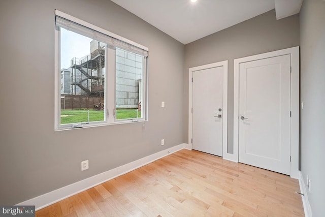 unfurnished bedroom featuring light hardwood / wood-style floors and multiple windows