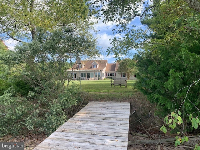 view of dock featuring a lawn