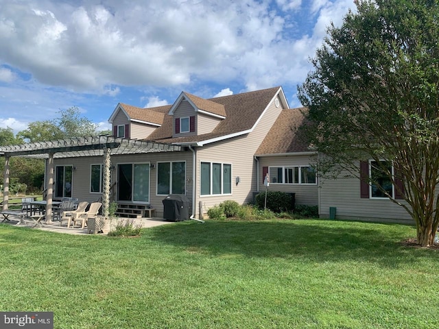 back of property with a lawn, a pergola, and a patio area