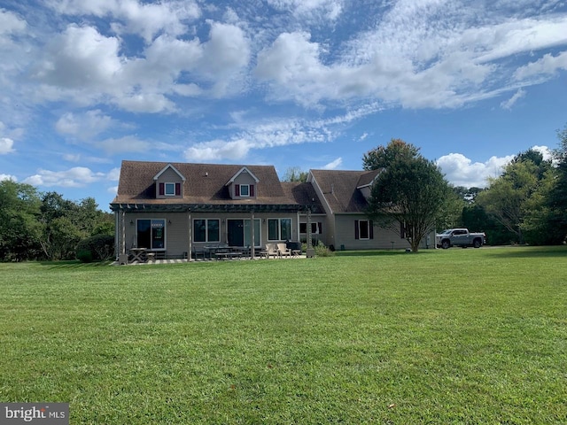 rear view of house with a yard and covered porch