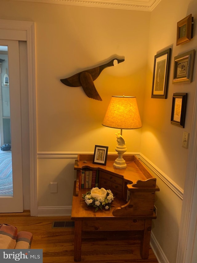 interior details featuring hardwood / wood-style flooring and ornamental molding