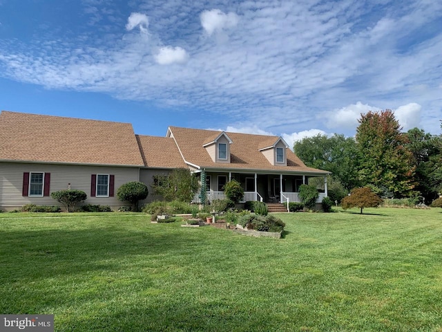 rear view of house featuring a yard and a porch