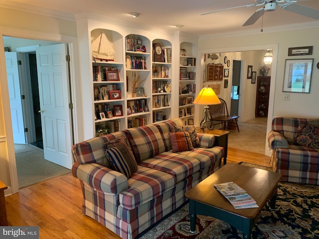 living room featuring ceiling fan, crown molding, and light hardwood / wood-style floors