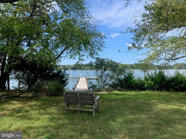 view of yard featuring a water view and a dock