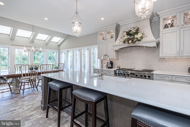 kitchen with pendant lighting, white cabinets, and decorative backsplash