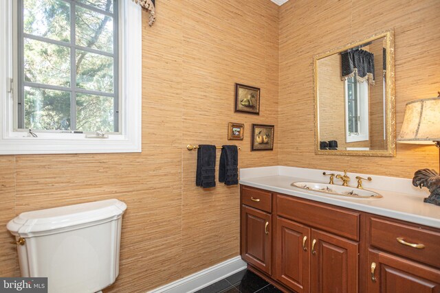 bathroom featuring a wealth of natural light, tile patterned flooring, vanity, and toilet