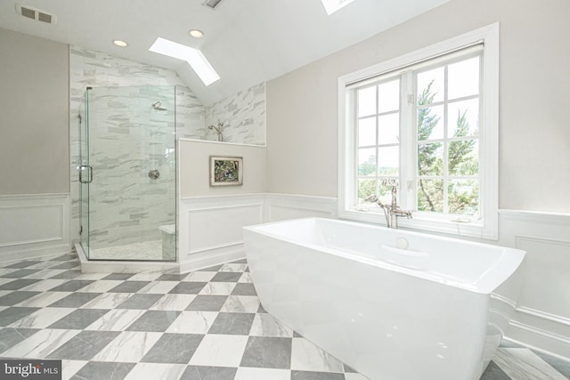 bathroom with shower with separate bathtub and lofted ceiling with skylight