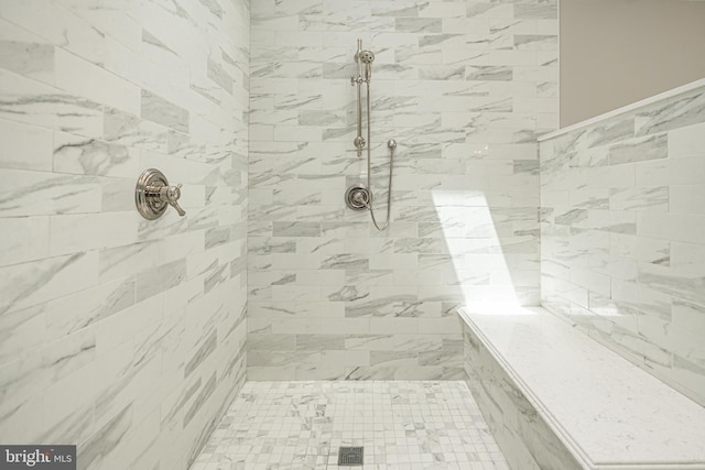 bathroom with a tile shower