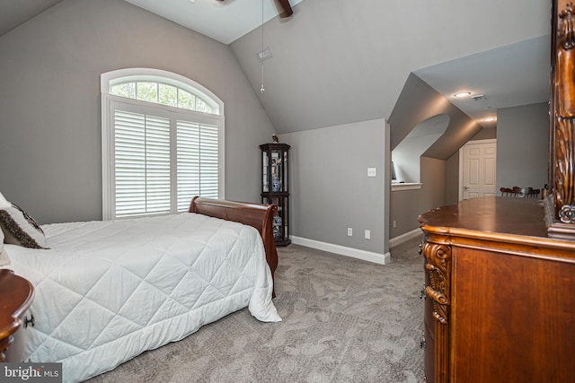 carpeted bedroom featuring lofted ceiling and ceiling fan