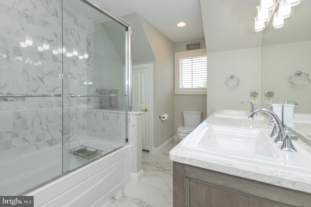 full bathroom featuring combined bath / shower with glass door, vanity, and toilet