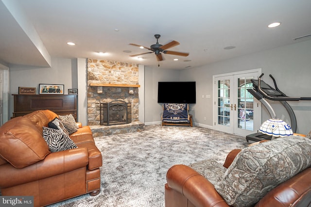 living room featuring ceiling fan, carpet flooring, a fireplace, and french doors