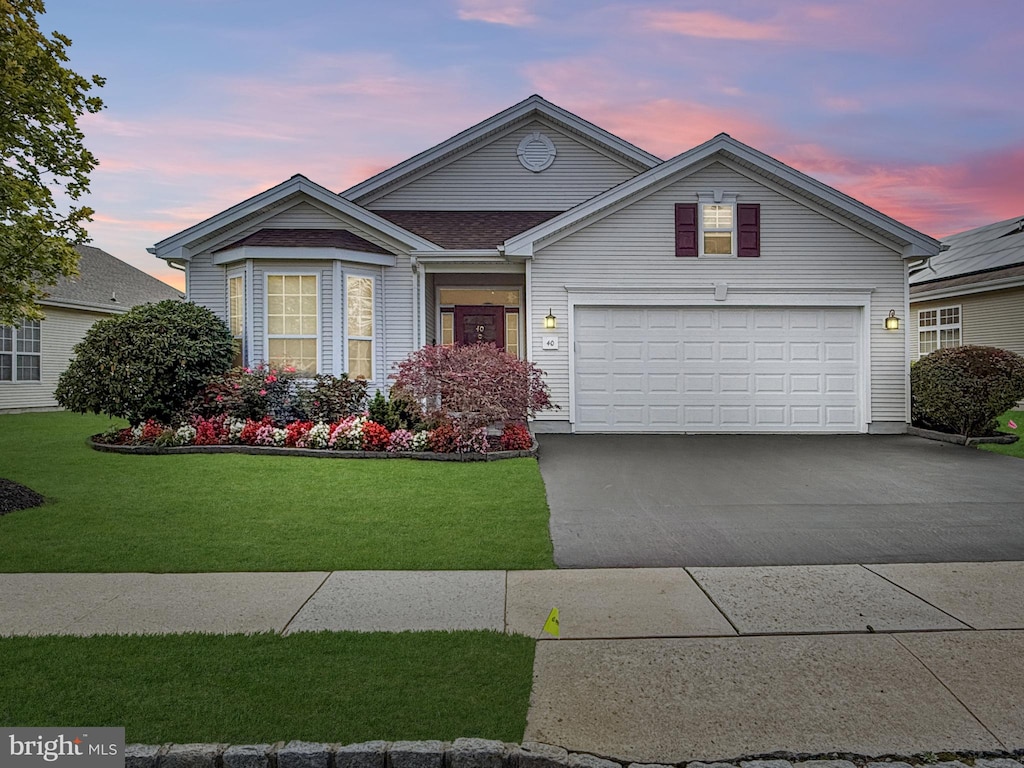 view of front of house with a lawn and a garage