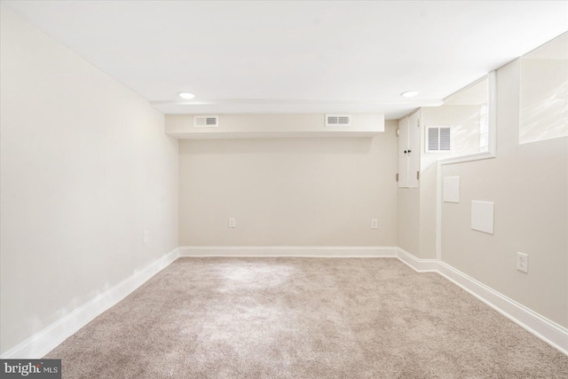 basement featuring light colored carpet